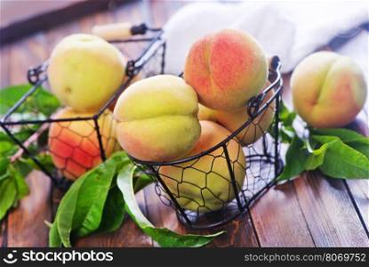 fresh peach in basket and on the wooden table