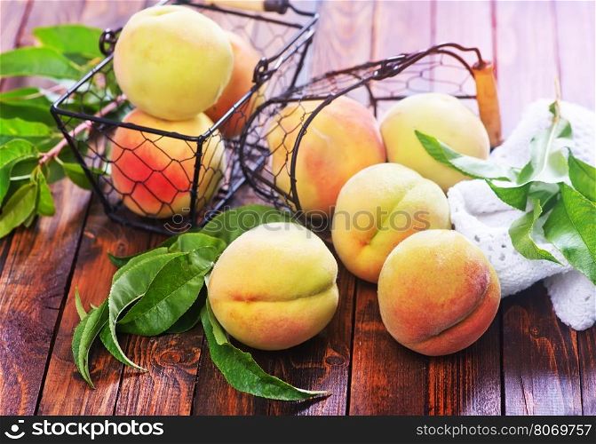 fresh peach in basket and on the wooden table