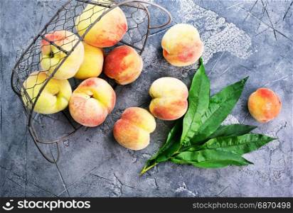 fresh peach in metal basket and on a table