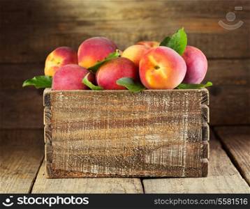 fresh peaches in wooden box