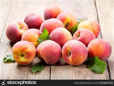 fresh peaches on wooden table