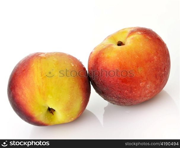 fresh peaches with waterdrops on white background