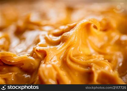 Fresh peanut butter. Macro background. The texture of peanut butter. High quality photo. Fresh peanut butter. Macro background.