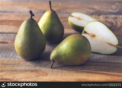 Fresh pears on the wooden background