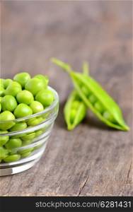Fresh peas isolated on old wooden background