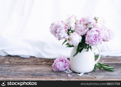 Fresh peonies flowersin vase on wooden windowsil, , summer background. Fresh peonies flowers