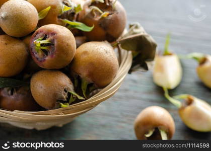 Fresh picked medlars in a basket, close up