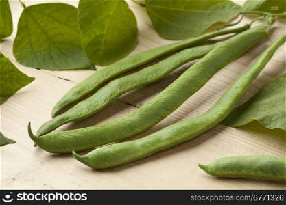 Fresh picked runner beans and leaves close up