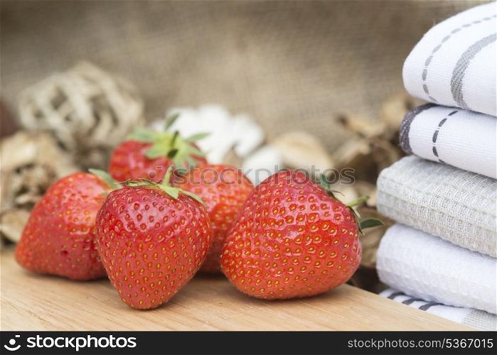 Fresh picked Summer strawberries on rustic wooden background. Macro shot of fresh Summer strawberries