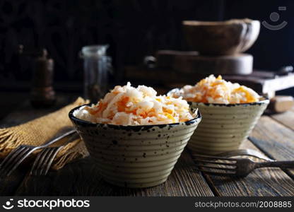 fresh pickled cabbage (german sauerkraut) with ingredients in bowl