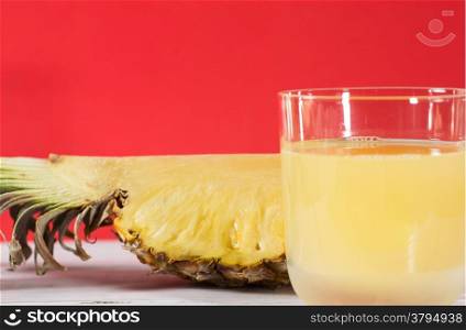 Fresh pineapple juice with red background