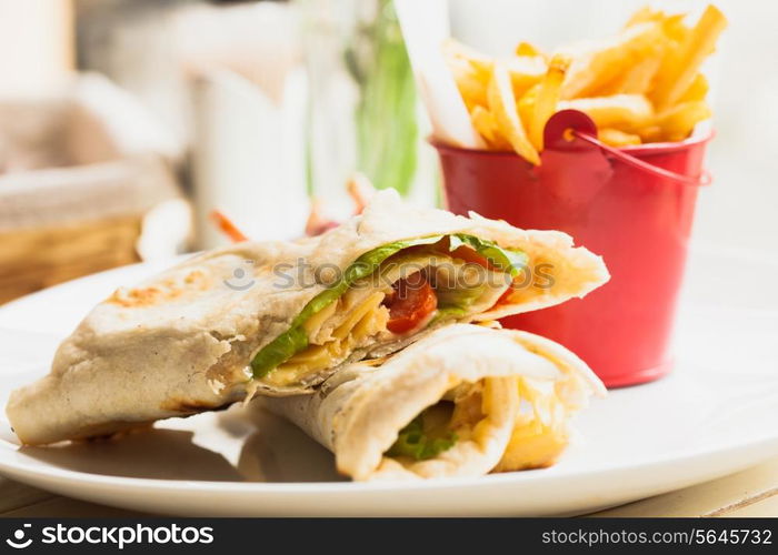 Fresh pita sandwich with French fries and salad