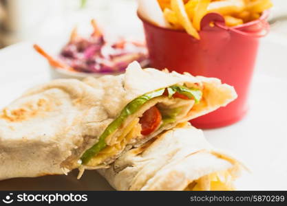 Fresh pita sandwich with French fries and salad. pita sandwich