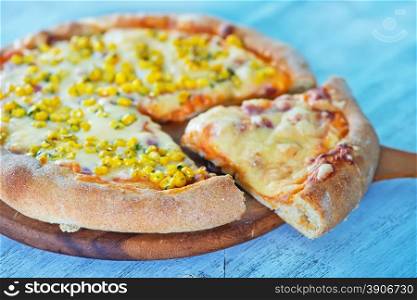 fresh pizza with cheese and corn on the board