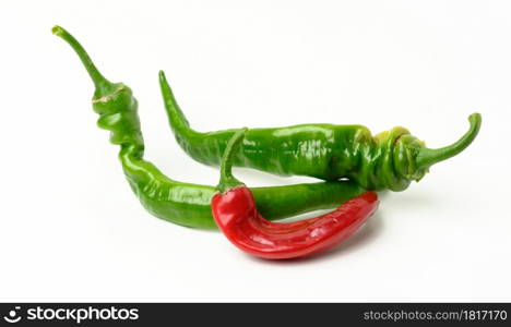 fresh pods of hot pepper on a white table. Hot spice