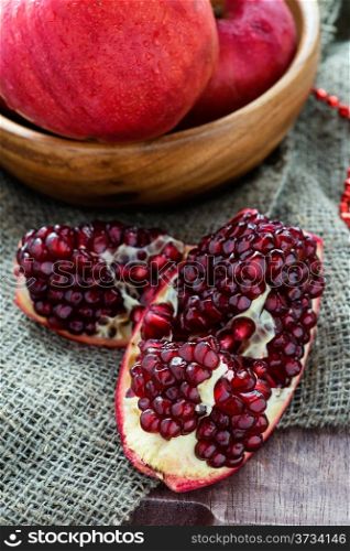 Fresh pomegranate over rustic background, selective focus