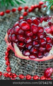 Fresh pomegranate with festive decorations, selective focus