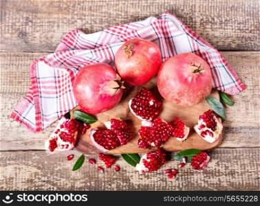 fresh pomegranates on wooden board