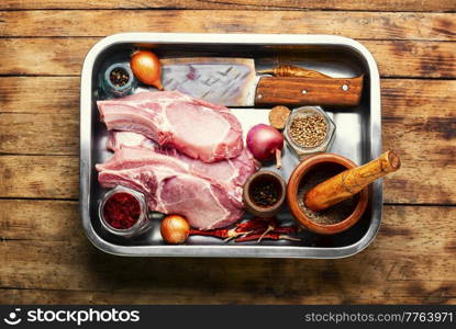 Fresh pork meat for cooking. Pork loin in tray. Raw pork on old wooden background