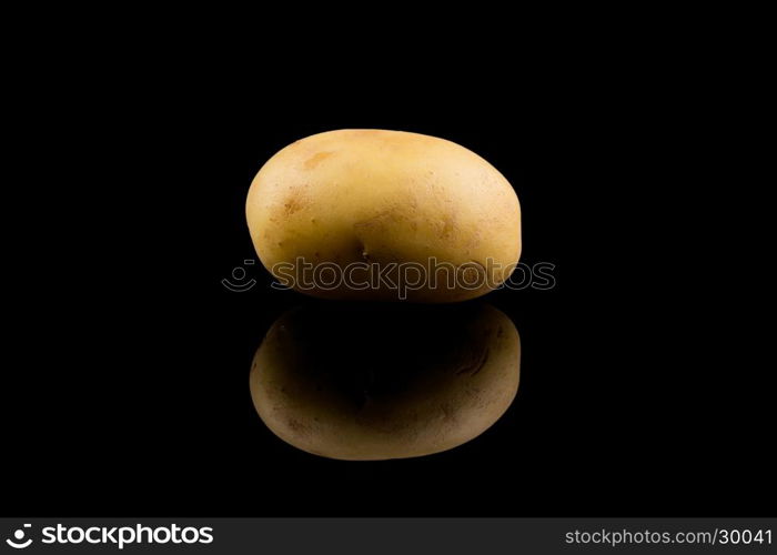 Fresh potato isolated on black backgrounf with reflection