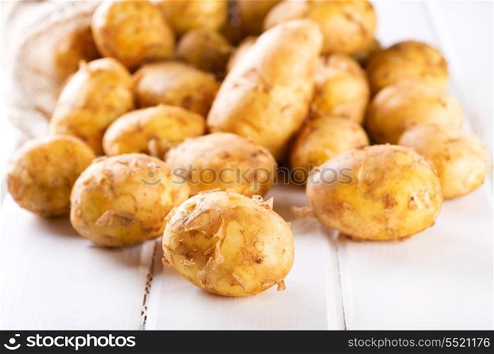 fresh potatoes on wooden table