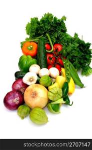 Fresh produce on a white background including red and yellow onions, tomatillos, cucumber, lettuce, cilatro, peas, sweet and hot peppers, tomatoes, zuchinni and summer squash. Assorted Vegetables On White