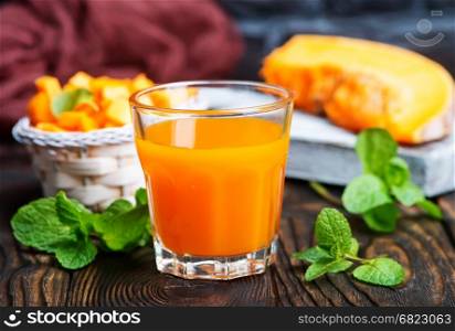 fresh pumpkin and juice on a table