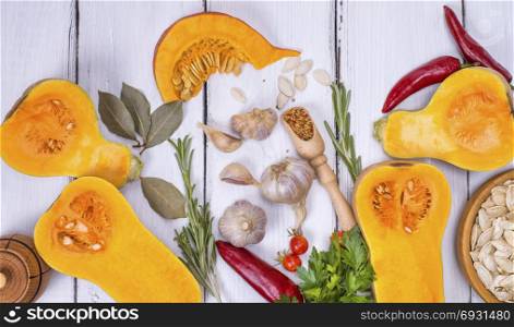 fresh pumpkin and pumpkin seeds on a white wooden background,