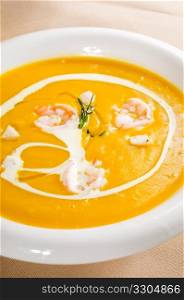 fresh pumpkin and shrimps cream soup ,with milk cream on top