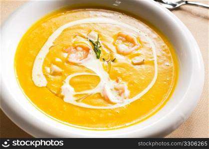 fresh pumpkin and shrimps cream soup ,with milk cream on top