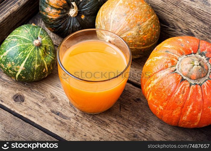 Fresh pumpkin juice.Autumn pumpkin drink.Juice on wooden table. Fresh pumpkin juice