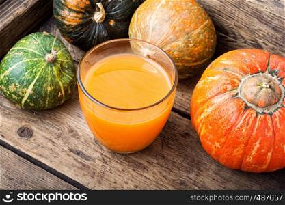 Fresh pumpkin juice.Autumn pumpkin drink.Juice on wooden table. Fresh pumpkin juice