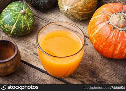 Fresh pumpkin juice in glass.Autumn pumpkin drink.Juice on wooden table. Fresh pumpkin juice