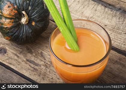 Fresh pumpkin juice in glass.Autumn pumpkin drink.Juice on wooden table. Fresh pumpkin juice