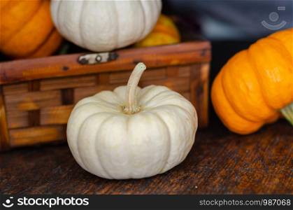 Fresh pumpkins on the wooden background in autumn