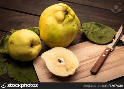 Fresh Quince fruit on wooden table. Cydonia oblonga