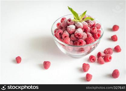Fresh raspberries in the glass bowl