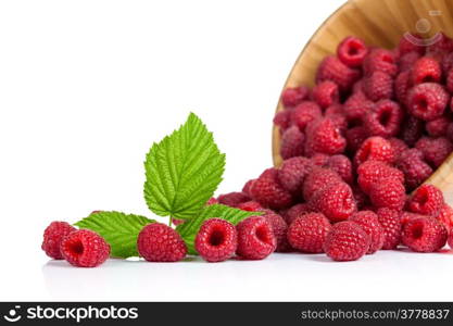 Fresh raspberries in wooden bowl on white background