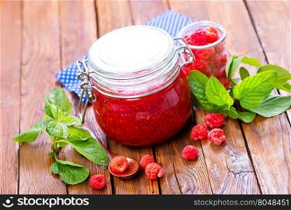 fresh raspberry and jam in glass bank