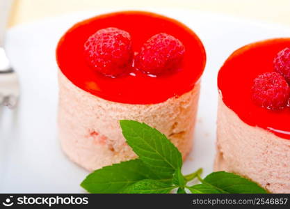 fresh raspberry cake mousse dessert round shape with mint leaves