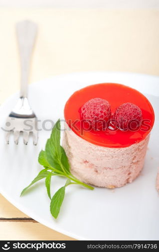 fresh raspberry cake mousse dessert round shape with mint leaves