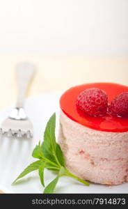 fresh raspberry cake mousse dessert round shape with mint leaves