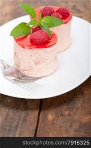 fresh raspberry cake mousse dessert round shape with mint leaves