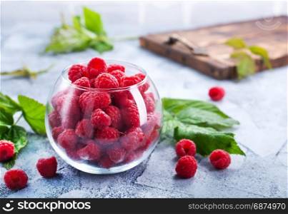 fresh raspberry in glass and on a table