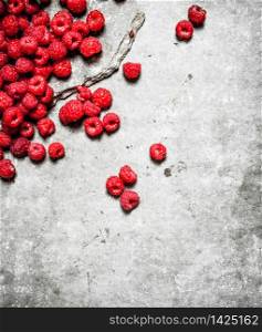 Fresh raspberry on table . On a stone background.. Fresh raspberry on table .