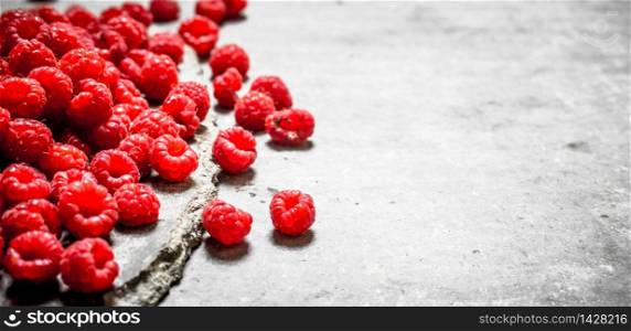 Fresh raspberry on table . On a stone background.. Fresh raspberry on table .