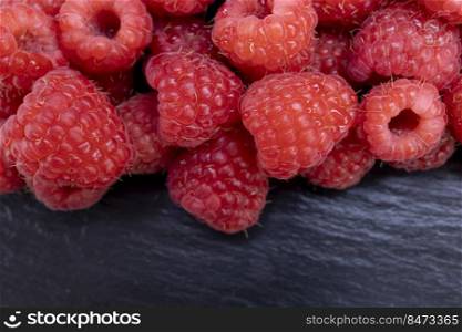 Fresh raspberry summer juicy fruits for a healthy diet. Organic raspberries for a healthy food and life concept.