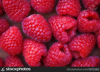 Fresh raspberry texture / Close up red raspberries fruit background top view