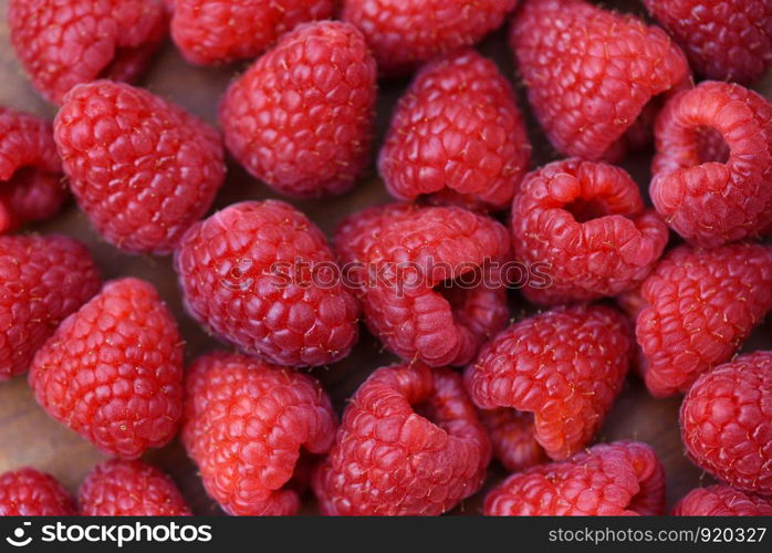 Fresh raspberry texture / Close up red raspberries fruit background top view