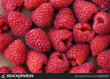 Fresh raspberry texture / Close up red raspberries fruit background top view